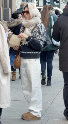 Clean white jeans, platform suede boots, and oversized brown sunglasses