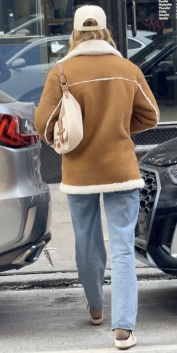 chestnut teddy coat with light-wash jeans and a simple buckle loafer
