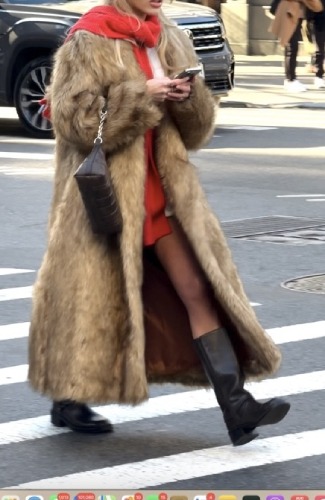 large grey sweater underneath and a striking red scarf