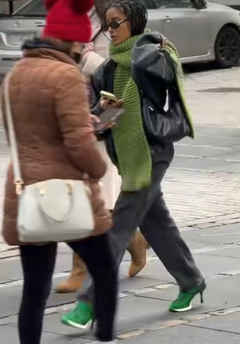leather bomber jacket, fitted black jeans, and a relaxed black shoulder bag