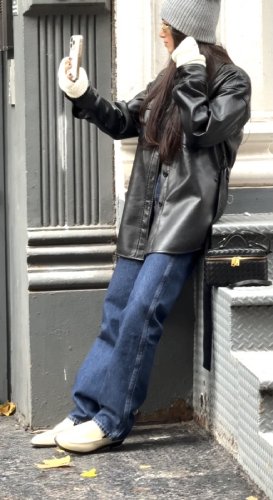 leather coat paired with dark wash jeans