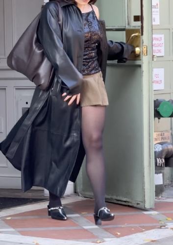 tan pleated skirt, a leather trench coat