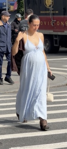 brown knit cardigan over her shoulders