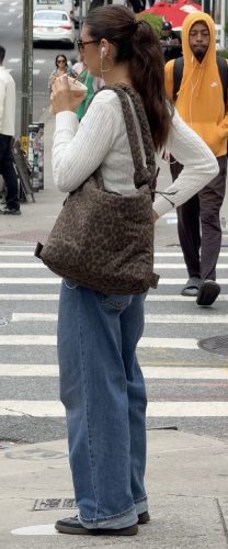 white cable-knit sweater and fitted jeans