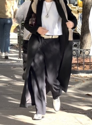 white t-shirt and a black trench coat
