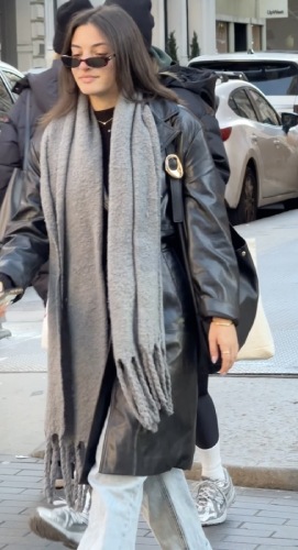 black trench coat and an oversized grey knit scarf