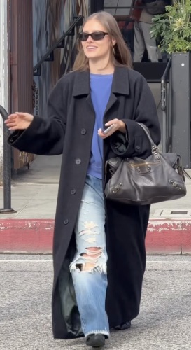 oversized black wool trench over a blue crewneck sweatshirt